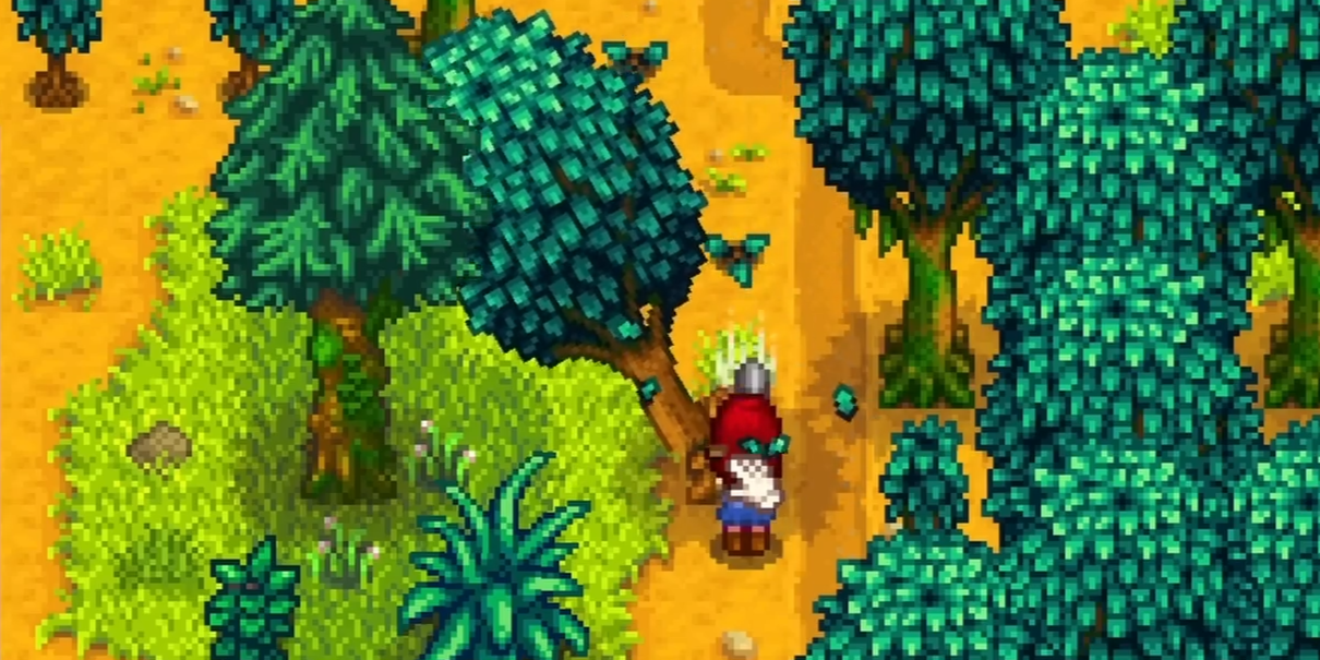 Stardew Valley character chopping down a tree with an axe to gain foraging experience